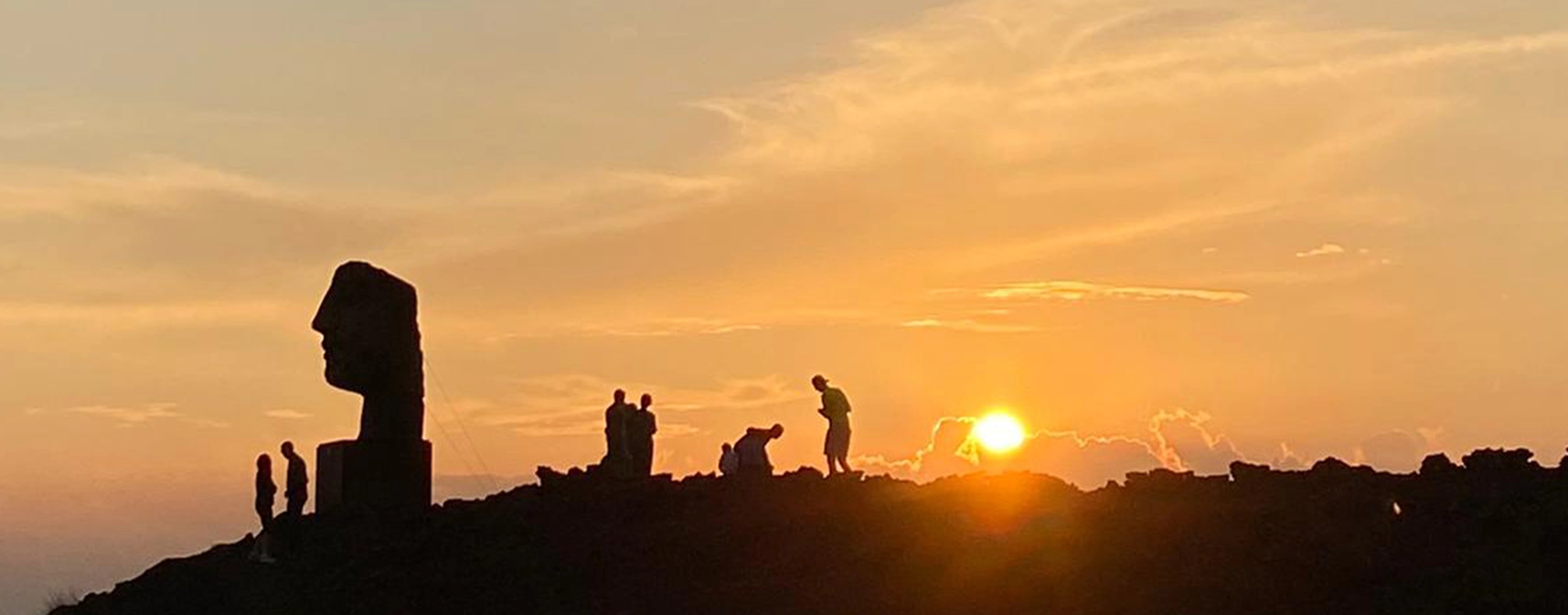 Hikers walking across the volcanic landscape of Mount Etna during a guided excursion